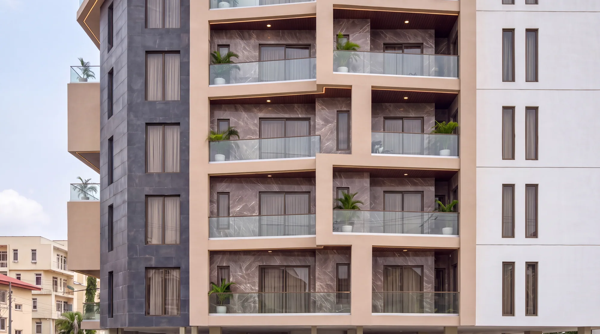 Stack of balconies with marble-clad recessed walls and glass balustrades