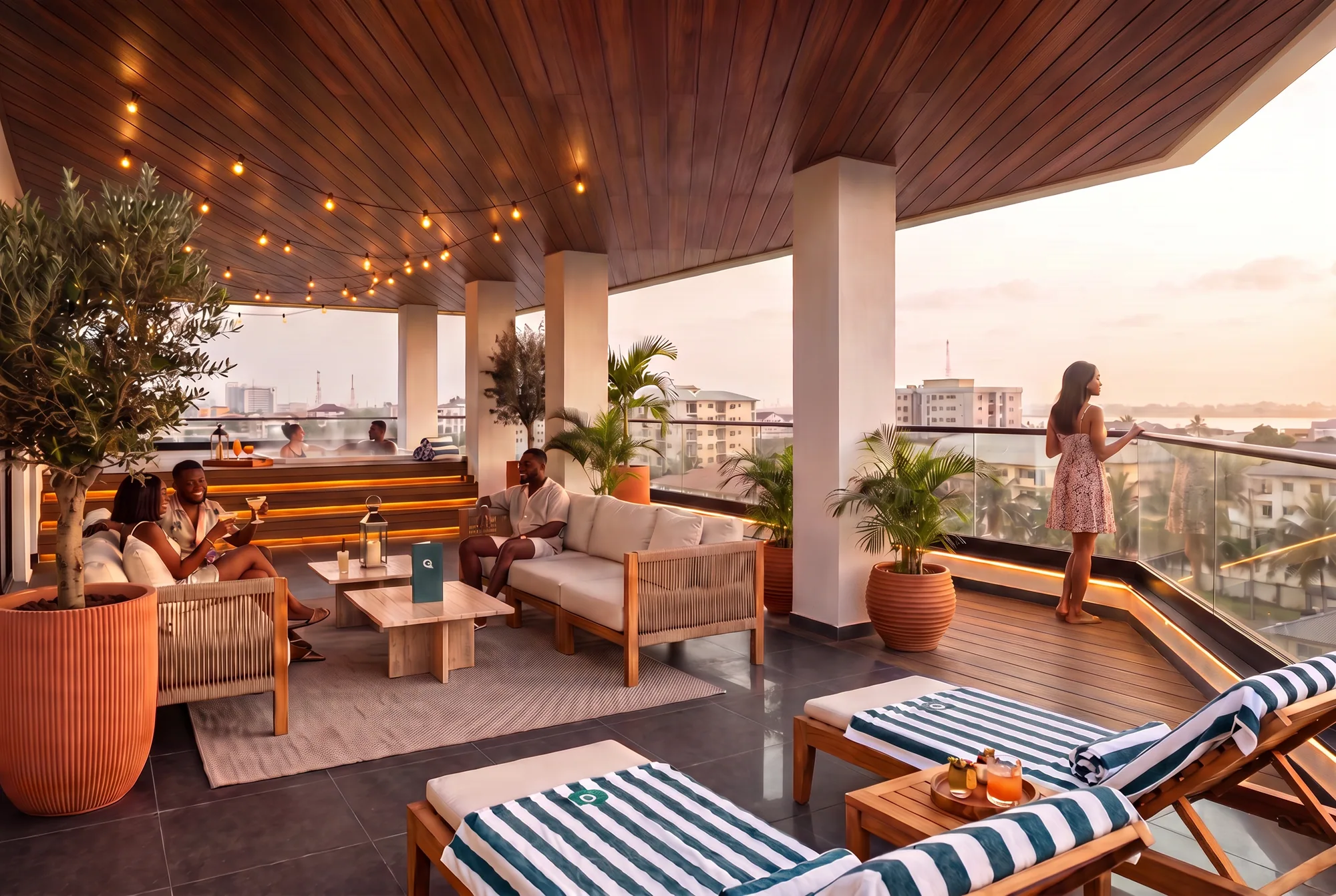 The rooftop at sunset: lounge seating, string lights and a view across Lekki